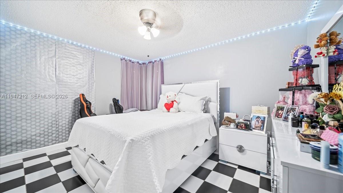 13430 Southwest 25th Street Miami, FL 33175 - Photo 14 of 49 a bed room with a bed and a black white checkered floor