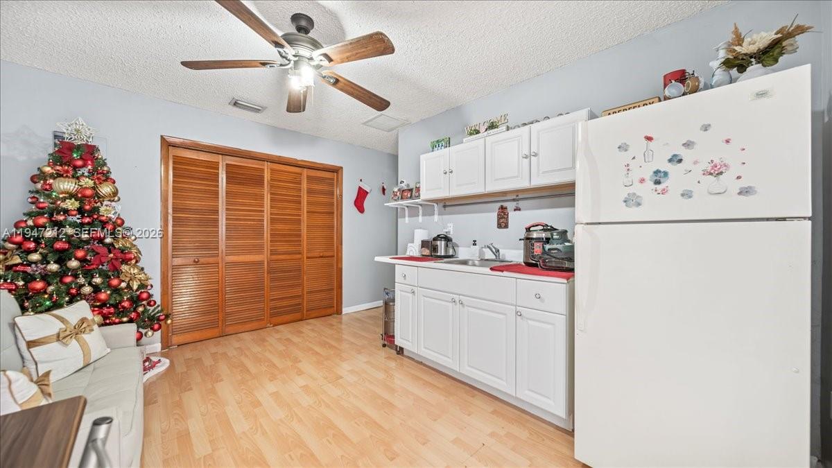 13430 Southwest 25th Street Miami, FL 33175 - Photo 18 of 49 a kitchen with granite countertop cabinets and white appliances