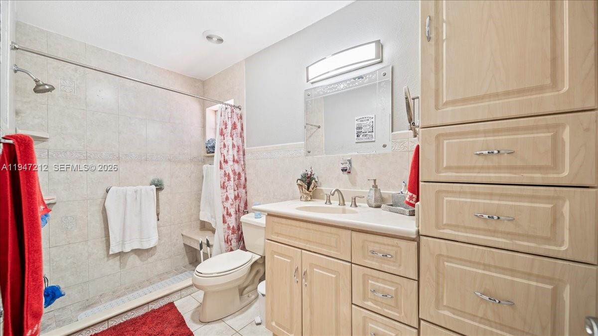 13430 Southwest 25th Street Miami, FL 33175 - Photo 21 of 49 a bathroom with a sink toilet vanity and shower