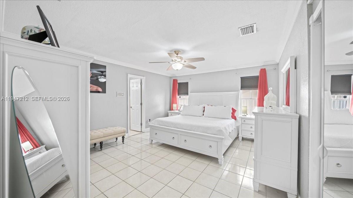 13430 Southwest 25th Street Miami, FL 33175 - Photo 23 of 49 a bedroom with a bed and a chandelier