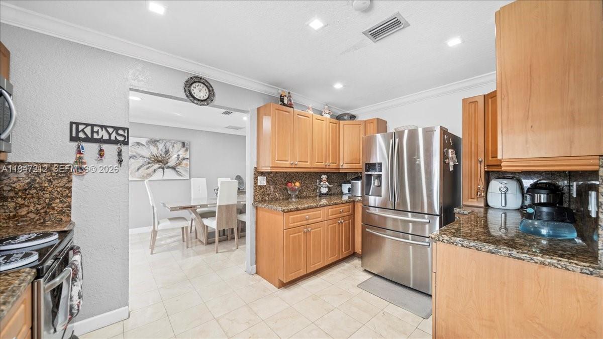 13430 Southwest 25th Street Miami, FL 33175 - Photo 26 of 49 a kitchen with stainless steel appliances granite countertop a refrigerator and a stove