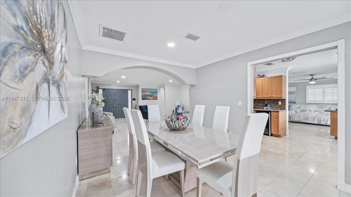 13430 Southwest 25th Street Miami, FL 33175 - Photo 28 of 49 a view of a dining room with furniture and a chandelier