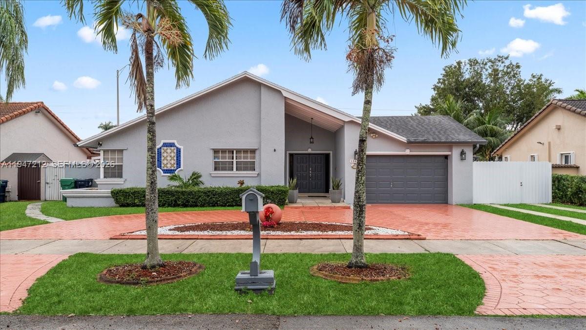 13430 Southwest 25th Street Miami, FL 33175 - Photo 3 of 49 a house with palm tree in front of it