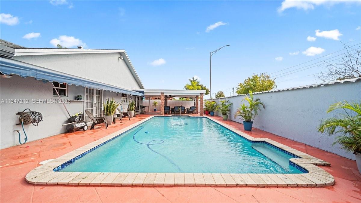 13430 Southwest 25th Street Miami, FL 33175 - Photo 39 of 49 a view of a living room and kitchen