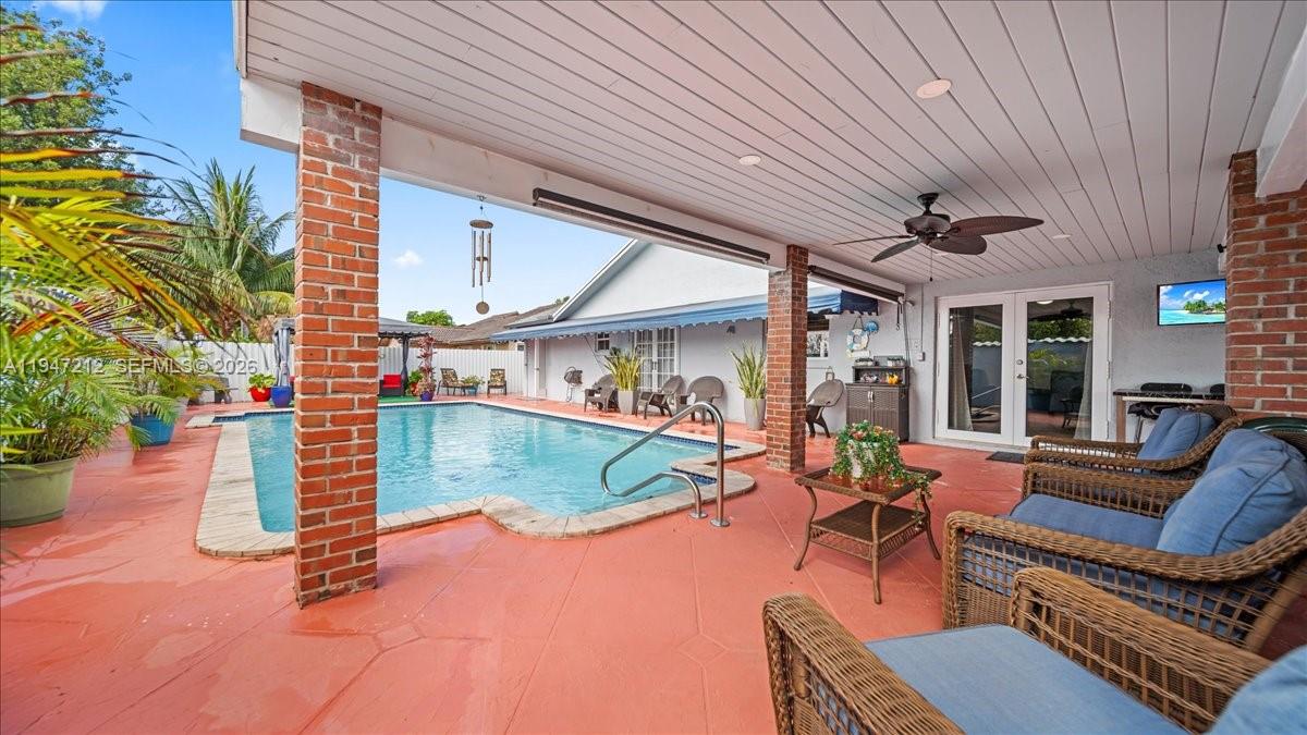 13430 Southwest 25th Street Miami, FL 33175 - Photo 40 of 49 a view of a patio with couches chairs and potted plants