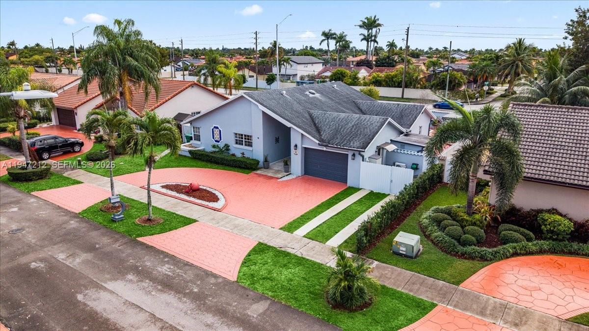 13430 Southwest 25th Street Miami, FL 33175 - Photo 47 of 49 a view of a house with a yard and potted plants