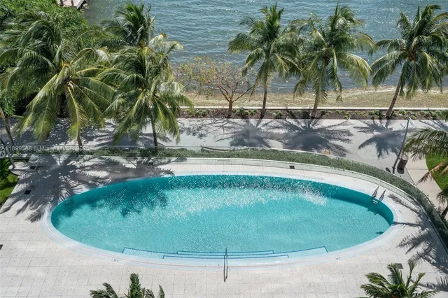 a view of a swimming pool with potted plants
