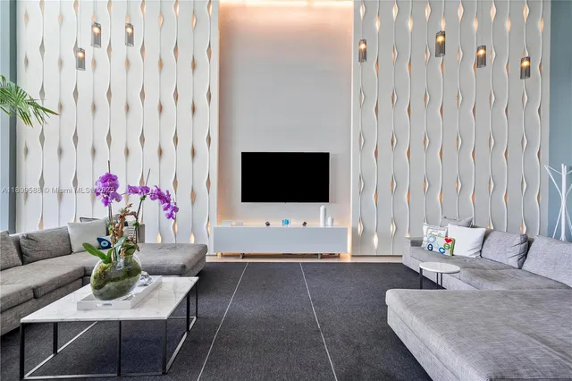 a living room with furniture and flowers