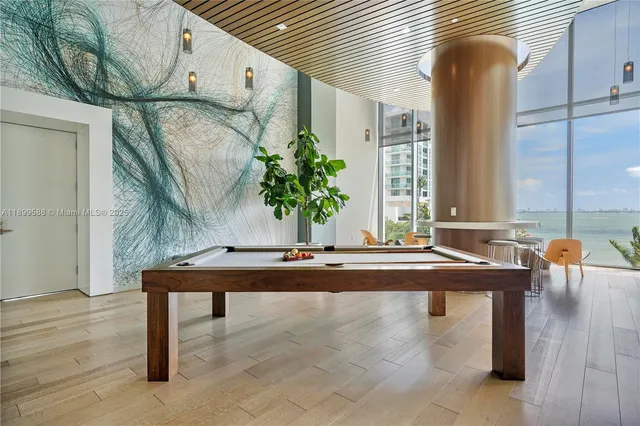 a view of a dining room with furniture and floor to ceiling window