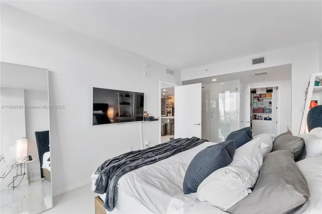 a bedroom with a bed and a television