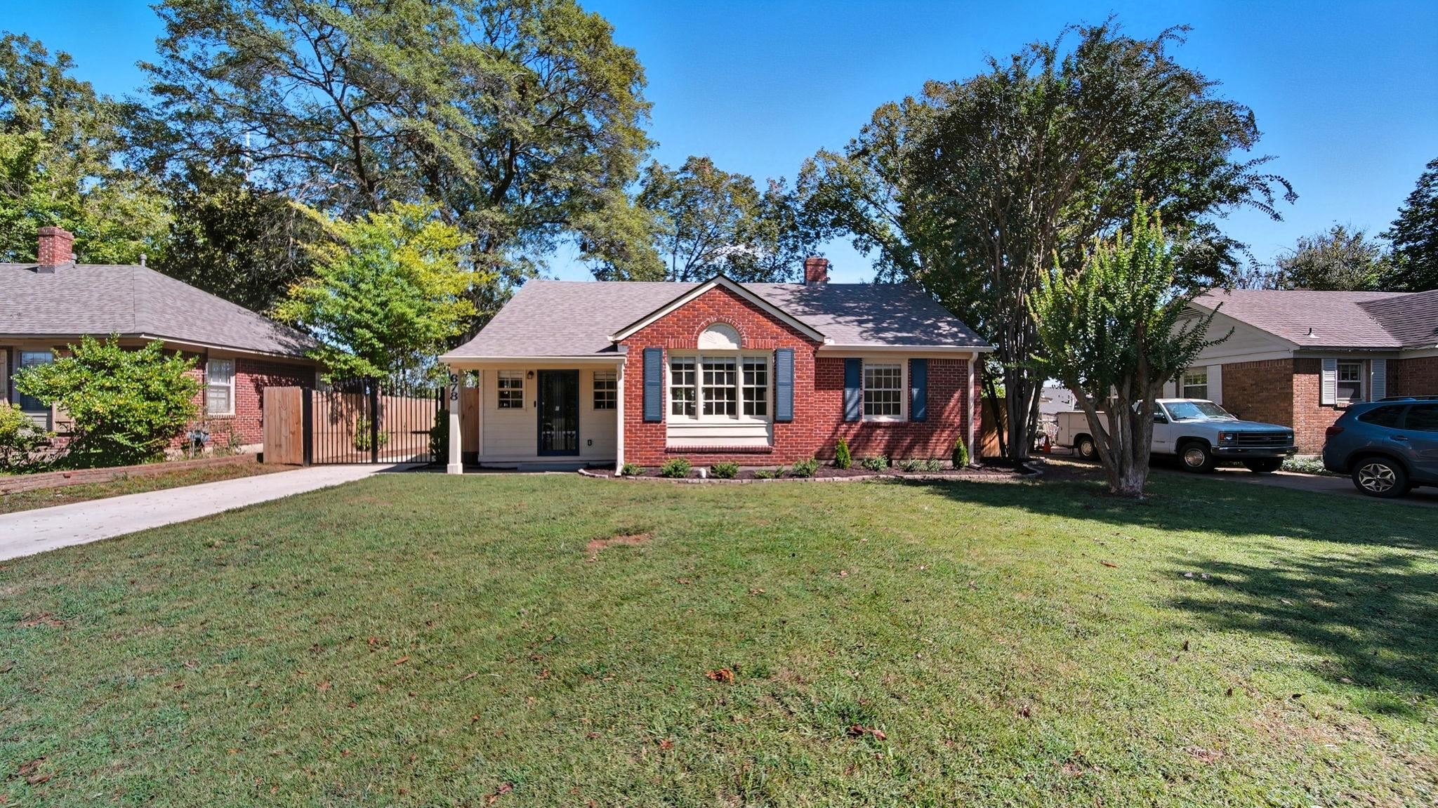 678 Moss Road Memphis, TN 38117 - Photo 1 of 33 View of front of house featuring brick siding, roof with shingles, a chimney, and a gate