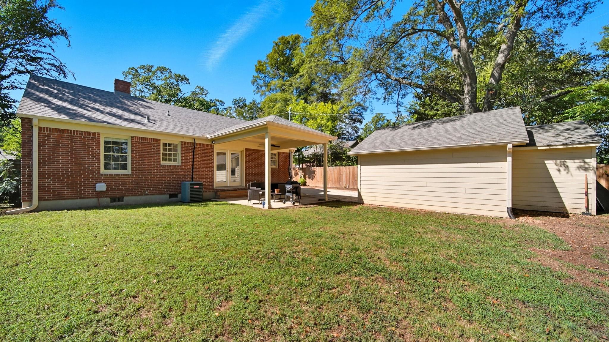 678 Moss Road Memphis, TN 38117 - Photo 12 of 33 Back of house featuring a patio, a chimney, and brick siding