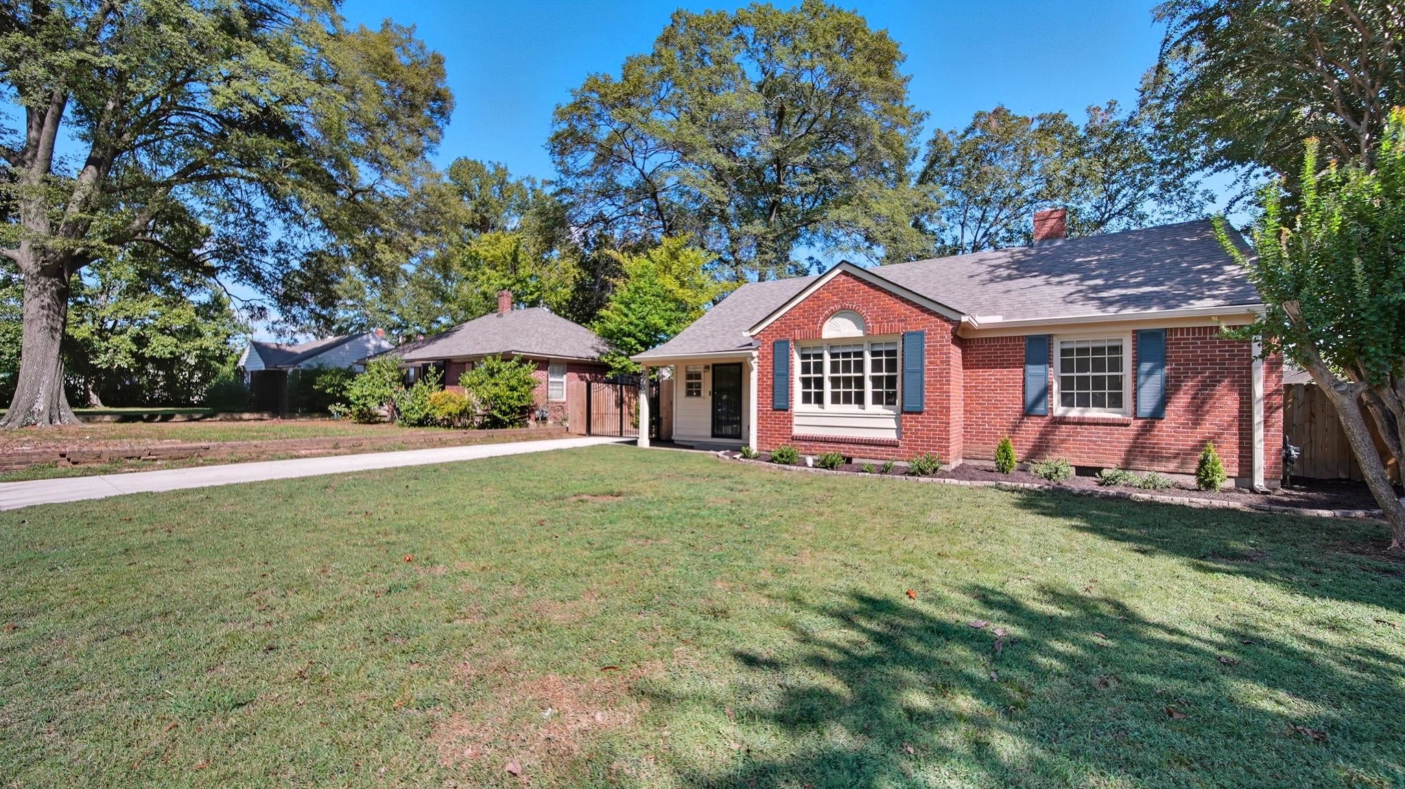 678 Moss Road Memphis, TN 38117 - Photo 18 of 33 Single story home featuring brick siding, a front yard, a chimney, and concrete driveway