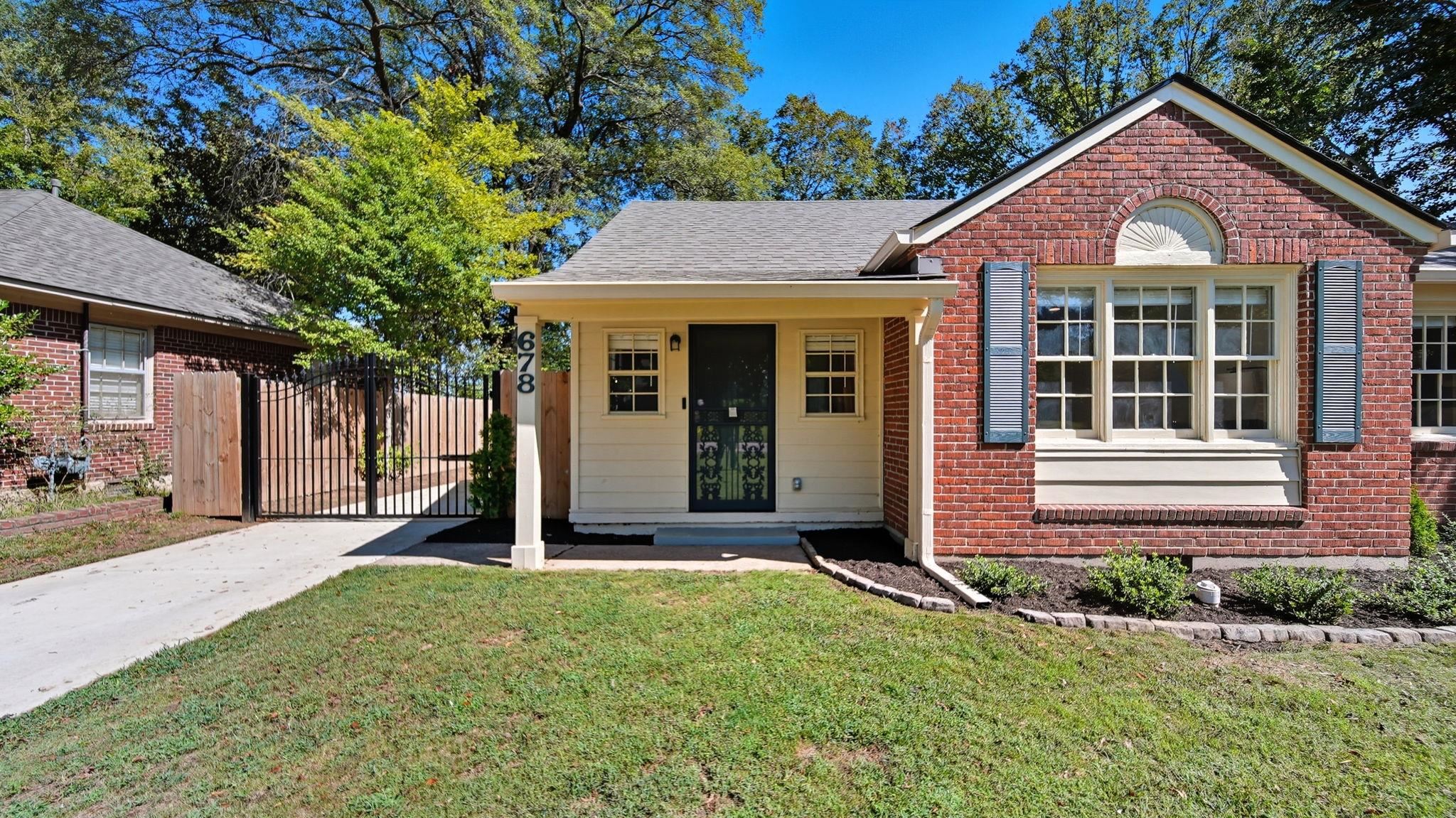 678 Moss Road Memphis, TN 38117 - Photo 3 of 33 View of front facade with a gate, brick siding, a porch, and roof with shingles