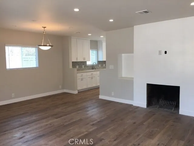 a view of kitchen with wooden floor and electronic appliances