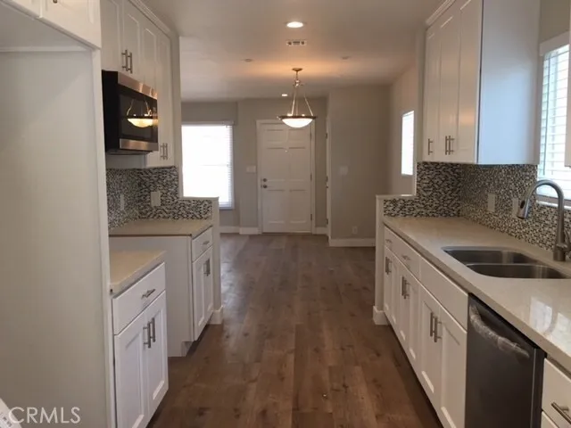 a kitchen with a sink and a refrigerator