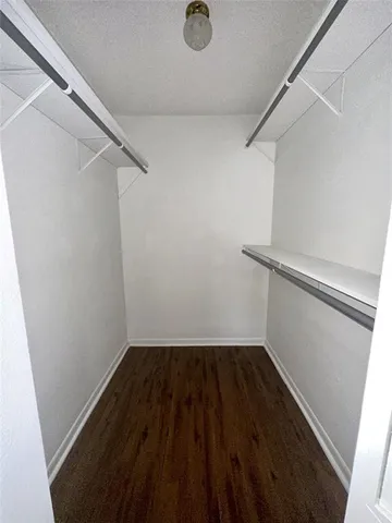 a view of storage and utility room with wooden floor