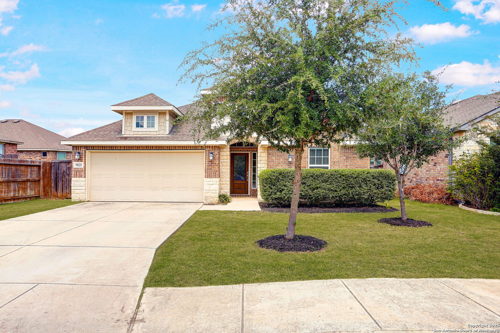 9825 Jon Boat Way Boerne, TX 78006 - Photo 3 of 24 a front view of a house with a yard garage and outdoor seating