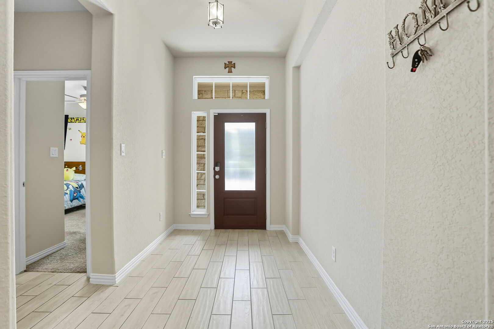 9825 Jon Boat Way Boerne, TX 78006 - Photo 4 of 24 a view of a hallway view with wooden floor and a bathroom