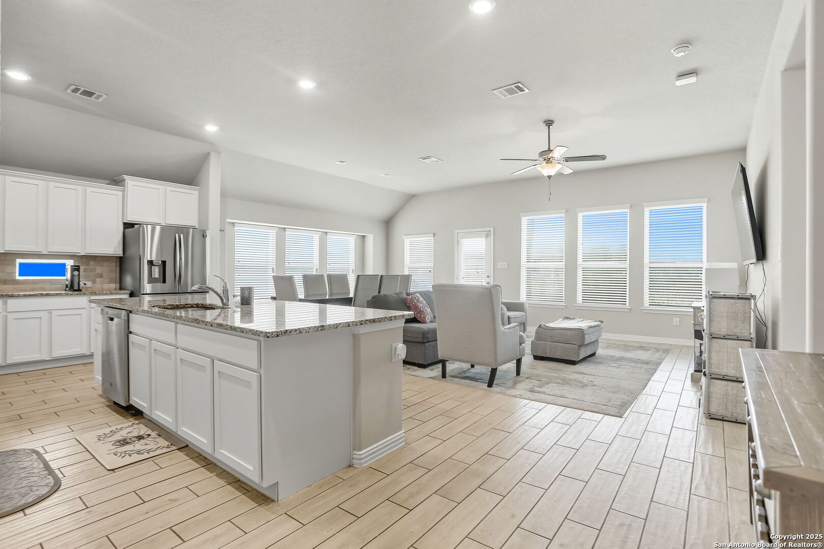 9825 Jon Boat Way Boerne, TX 78006 - Photo 6 of 24 a large kitchen with kitchen island a sink stainless steel appliances and cabinets