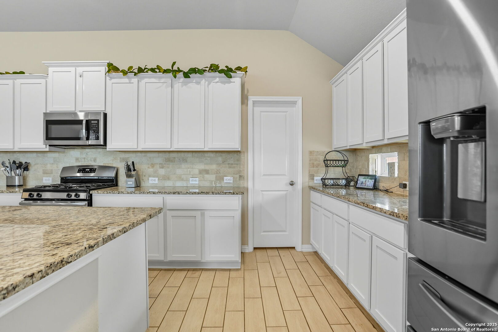 9825 Jon Boat Way Boerne, TX 78006 - Photo 8 of 24 a kitchen with a sink stove and refrigerator