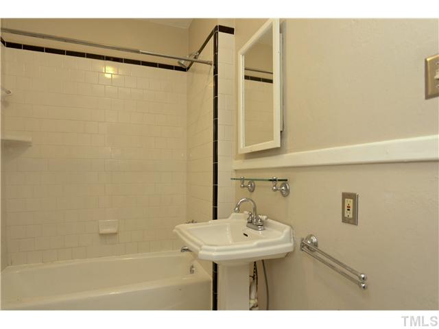 124 Hudson Street Raleigh, NC 27608 - Photo 13 of 19 a bathroom with a sink and mirror