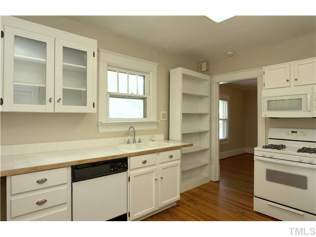 124 Hudson Street Raleigh, NC 27608 - Photo 9 of 19 a kitchen with a sink stove and cabinets