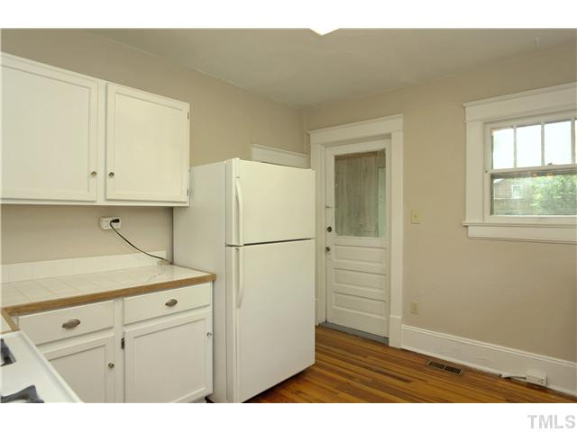 124 Hudson Street Raleigh, NC 27608 - Photo 10 of 19 a kitchen with cabinets appliances and a wooden floor