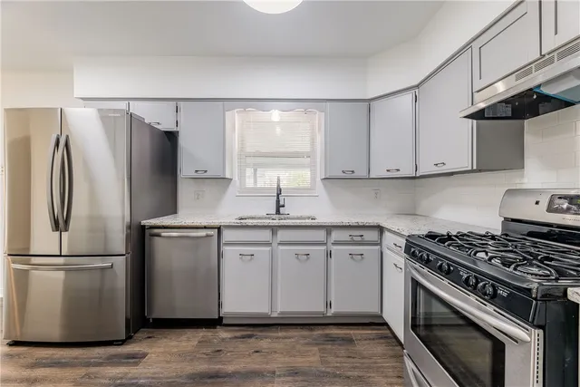 a kitchen with a sink stove and refrigerator