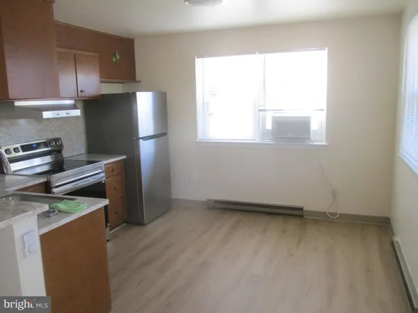 a kitchen with a refrigerator and window