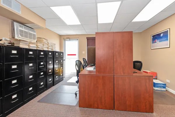 a workspace with furniture and a flat screen tv