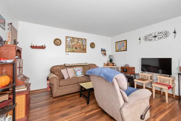 a kitchen with stainless steel appliances granite countertop a stove a sink and a microwave with white cabinets