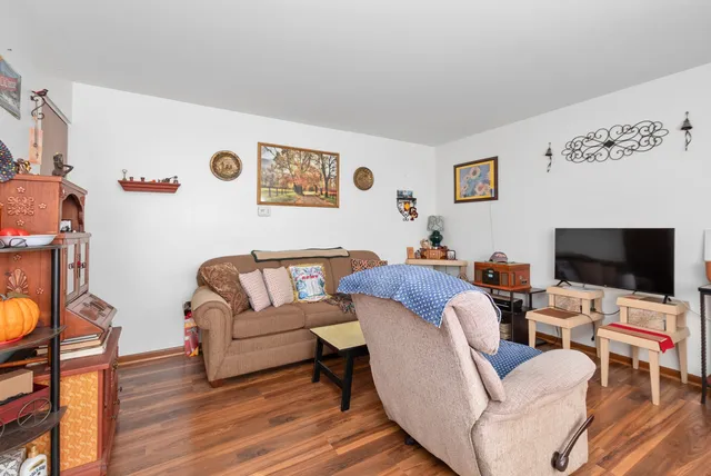 a kitchen with stainless steel appliances granite countertop a stove a sink and a microwave with white cabinets