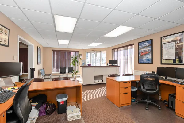 a view of a workspace with furniture and a window
