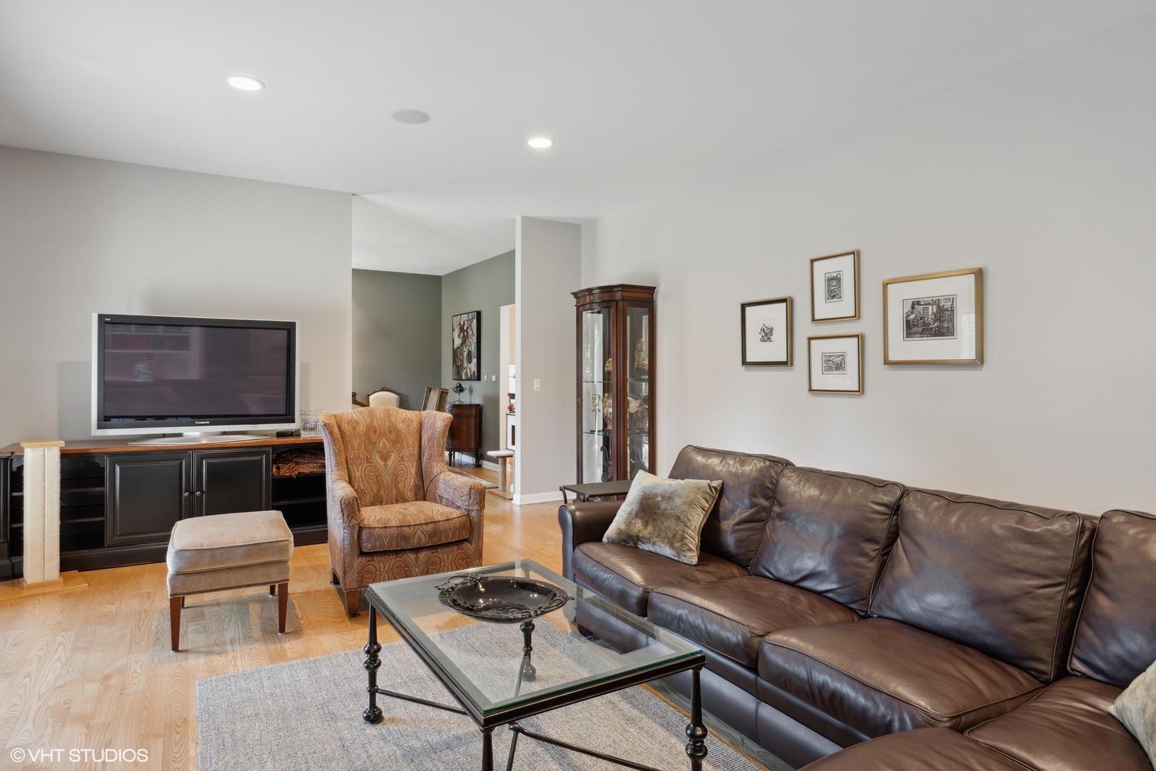 920 Pine Tree Lane Winnetka, IL 60093 - Photo 15 of 59 a living room with furniture a flat screen tv and kitchen view