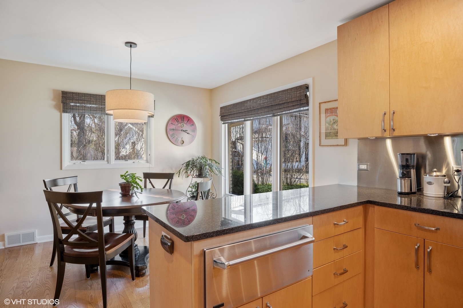 920 Pine Tree Lane Winnetka, IL 60093 - Photo 23 of 59 a dining room with wooden floor a chandelier a wooden table and chairs
