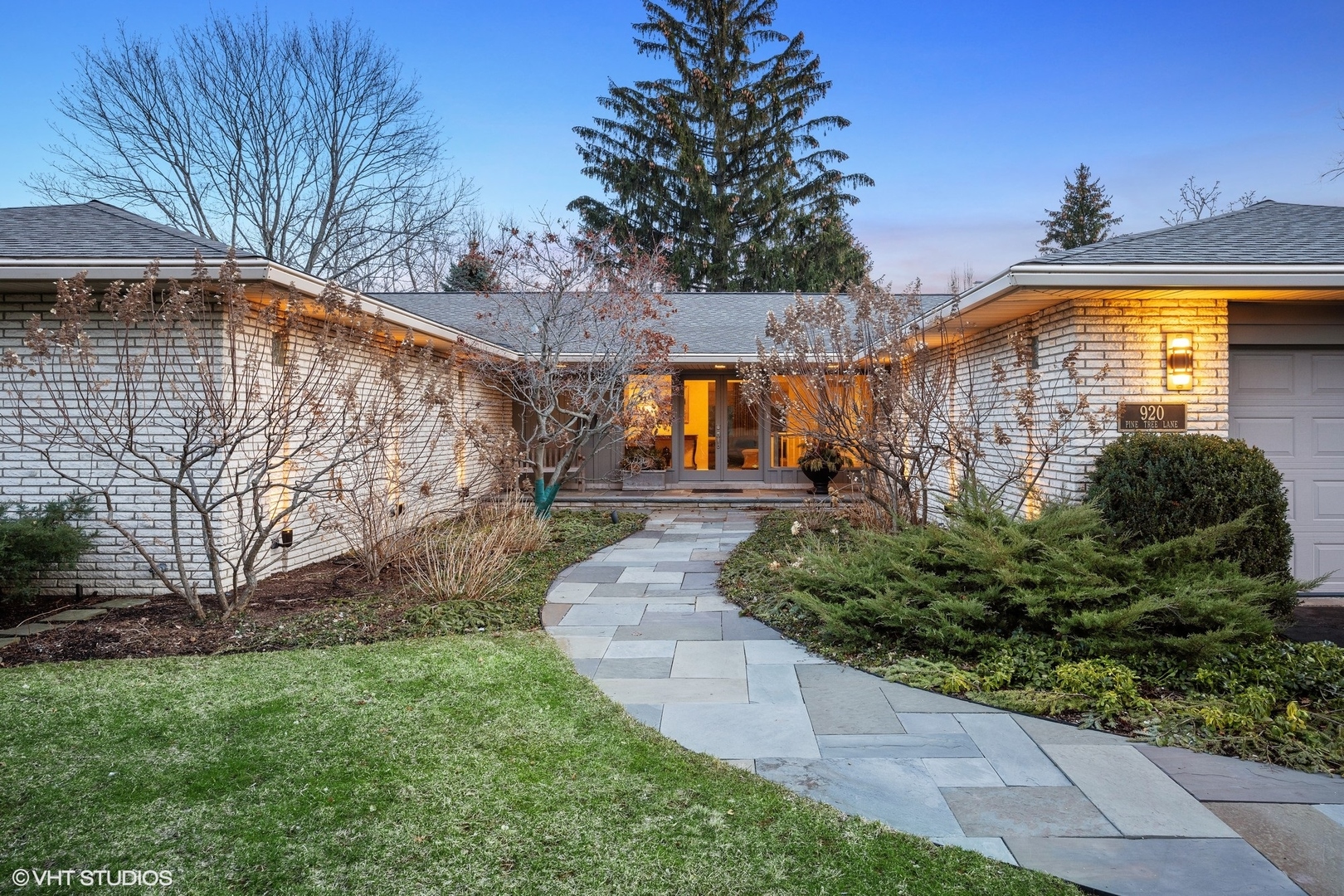 920 Pine Tree Lane Winnetka, IL 60093 - Photo 46 of 59 a front view of a house with garden