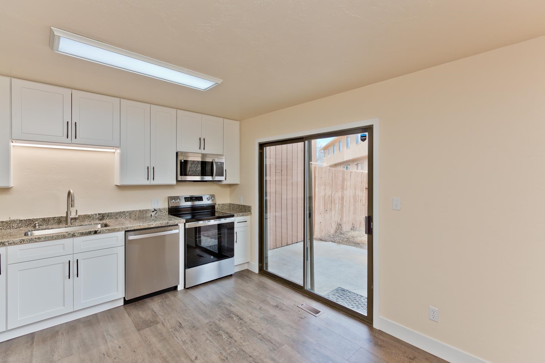 575-28 28 1/2 Road, Unit 44 Grand Junction, CO 81501 - Photo 8 of 39 a kitchen with stainless steel appliances granite countertop a stove a sink and a refrigerator