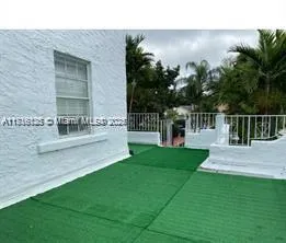 a view of house with backyard and garden
