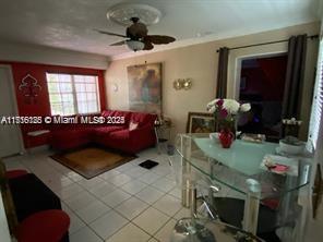 2633 Southwest 34th Avenue Miami, FL 33133 - Photo 2 of 16 a living room with furniture and a flat screen tv