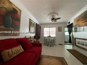 2633 Southwest 34th Avenue Miami, FL 33133 - Photo 5 of 16 a living room with furniture and a flat screen tv