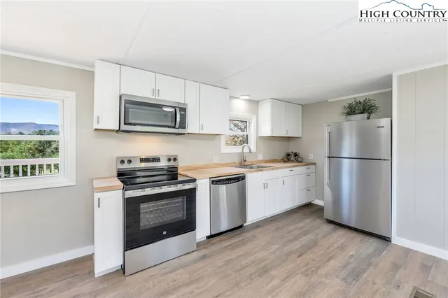 a kitchen with a refrigerator stove and microwave