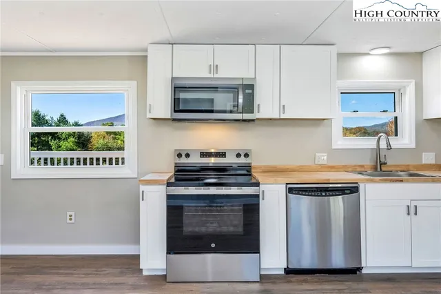 a kitchen with stainless steel appliances granite countertop a stove and a microwave