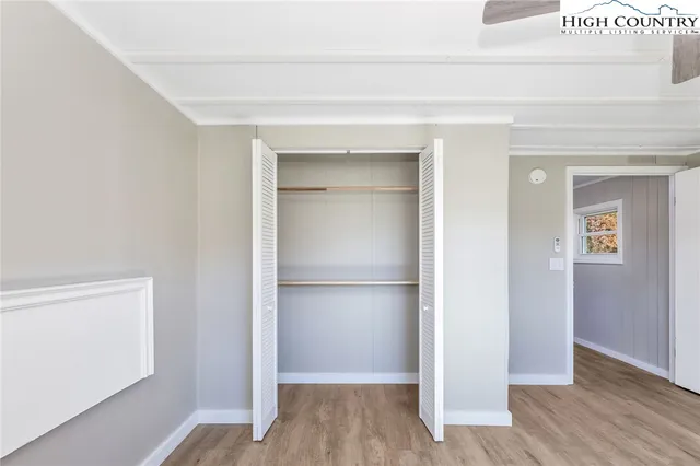 a view of a room with wooden floor