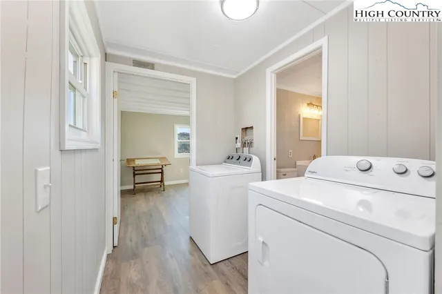 a view of washer and dryer with kitchen in the background