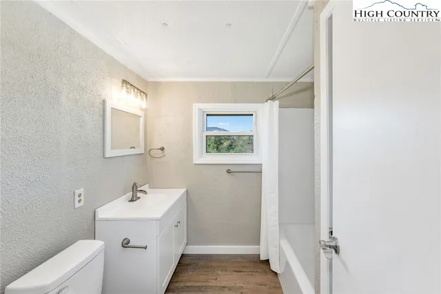 a bathroom with a sink and mirror with toilet