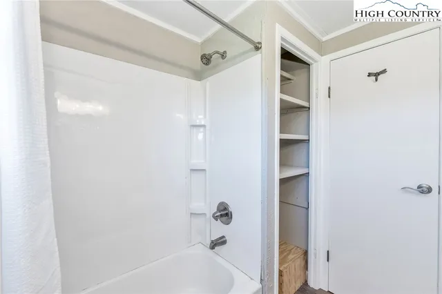 a bathroom with a bathtub and shower