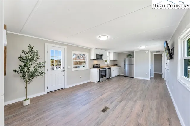 a view of a room with wooden floor and windows