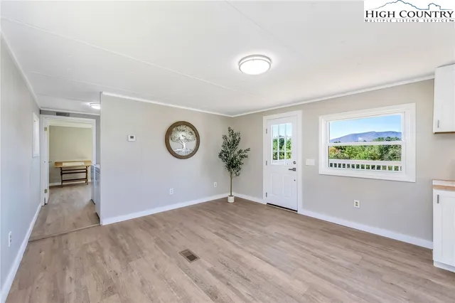 a view of a room with wooden floor and window