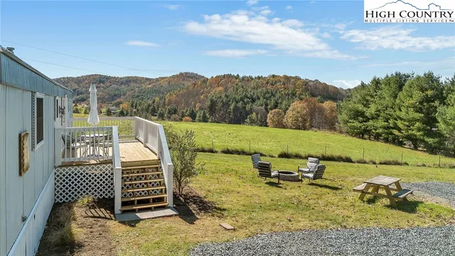 a view of a patio with a table chairs and a fire pit